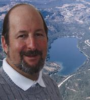 Photo of John Williamson with Donner Lake in background.